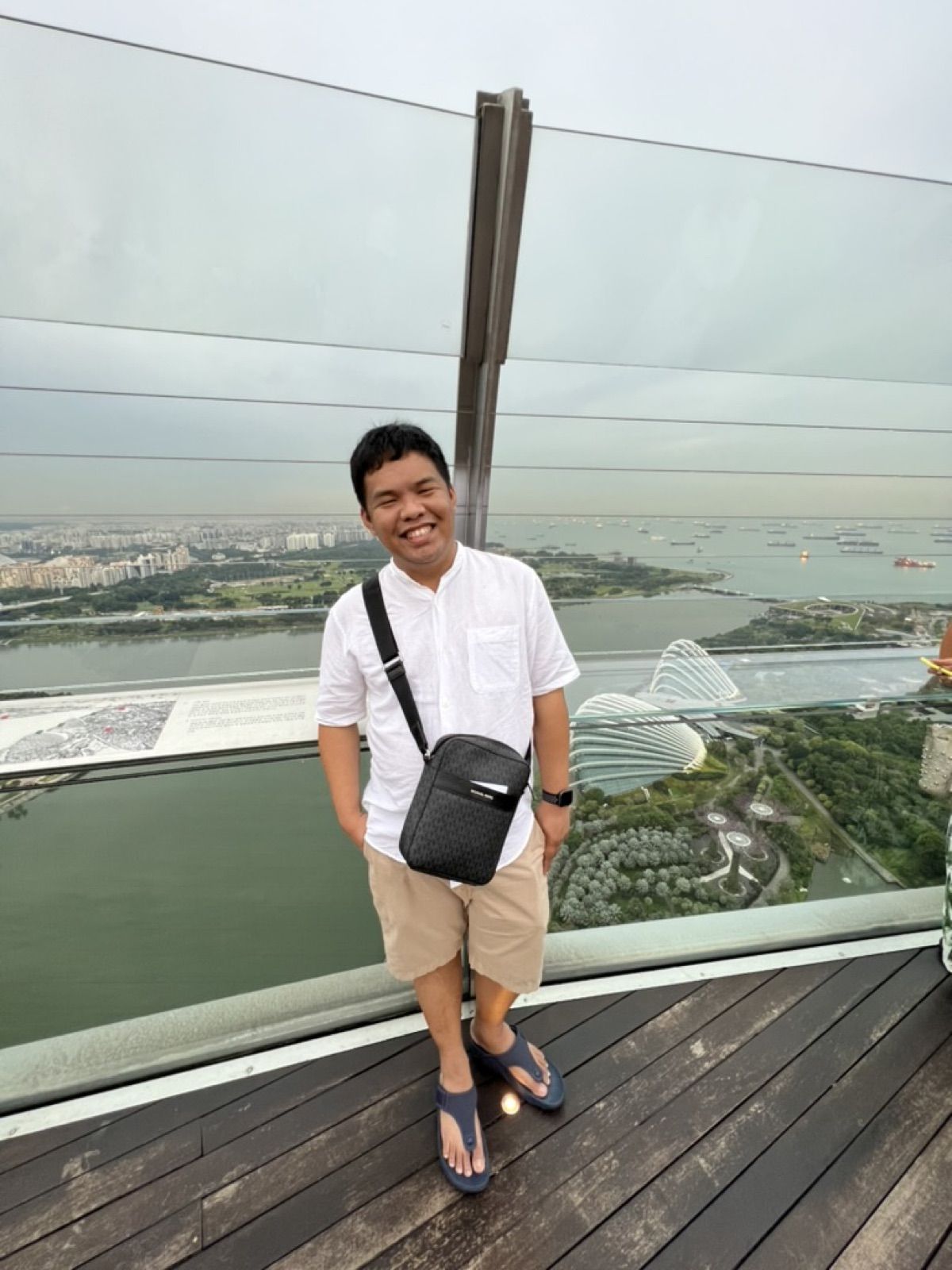 Allanaire on a glass skydeck above a city harbour