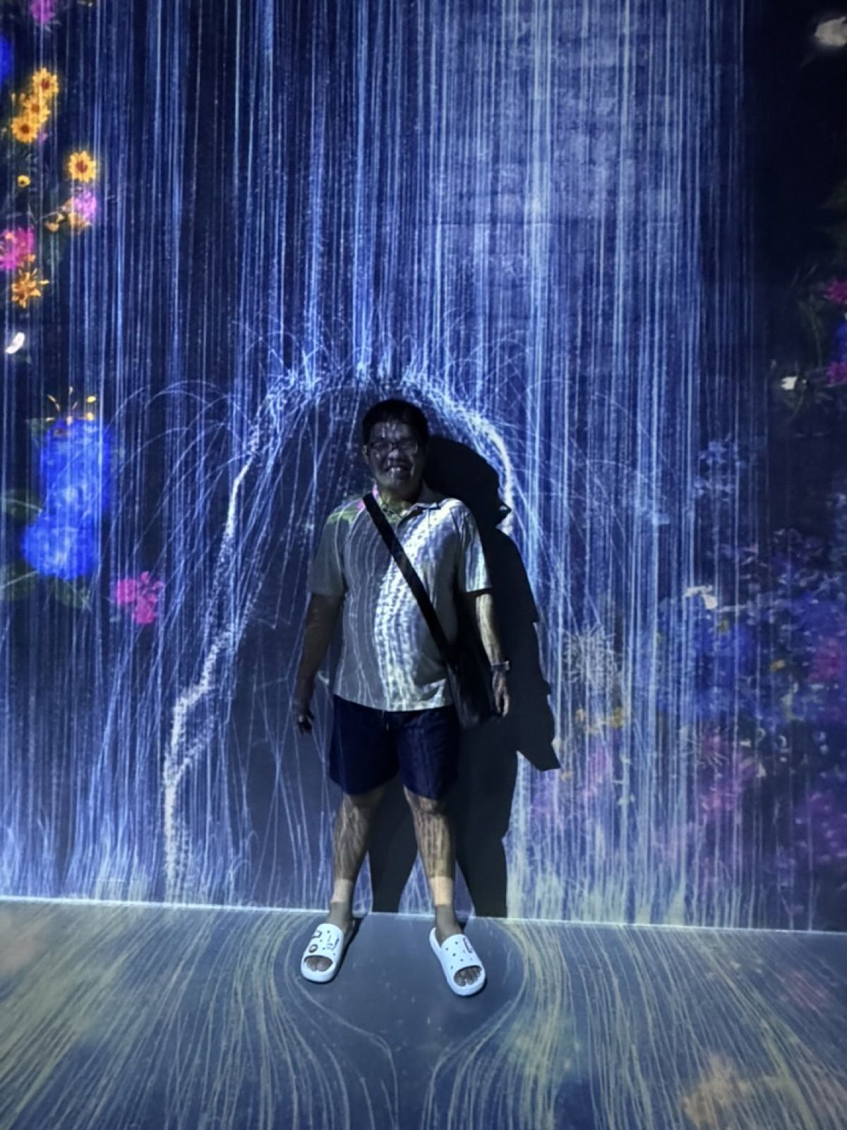 Allanaire standing inside a digital light installation