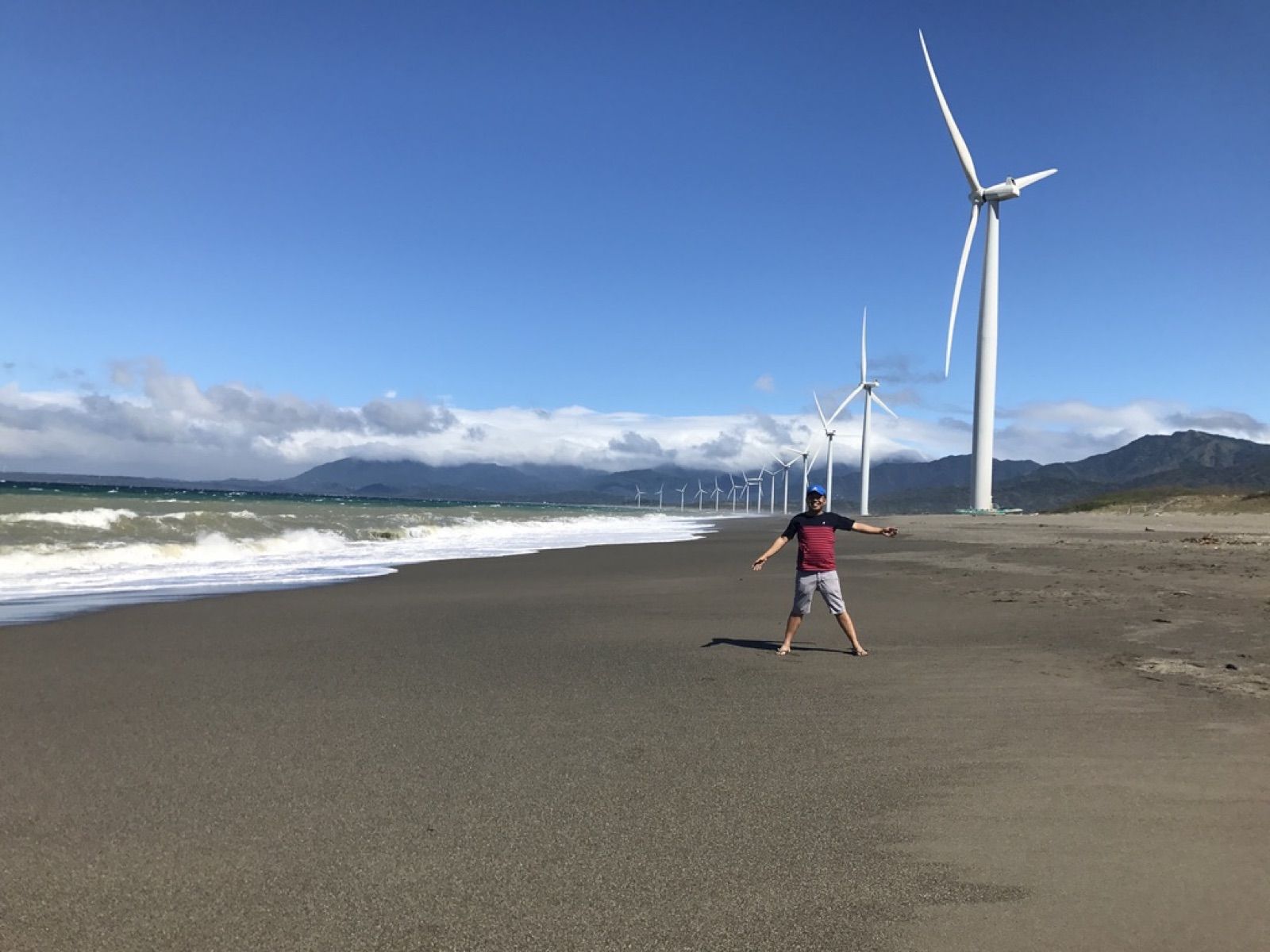 Allanaire on a wide beach below a row of wind turbines